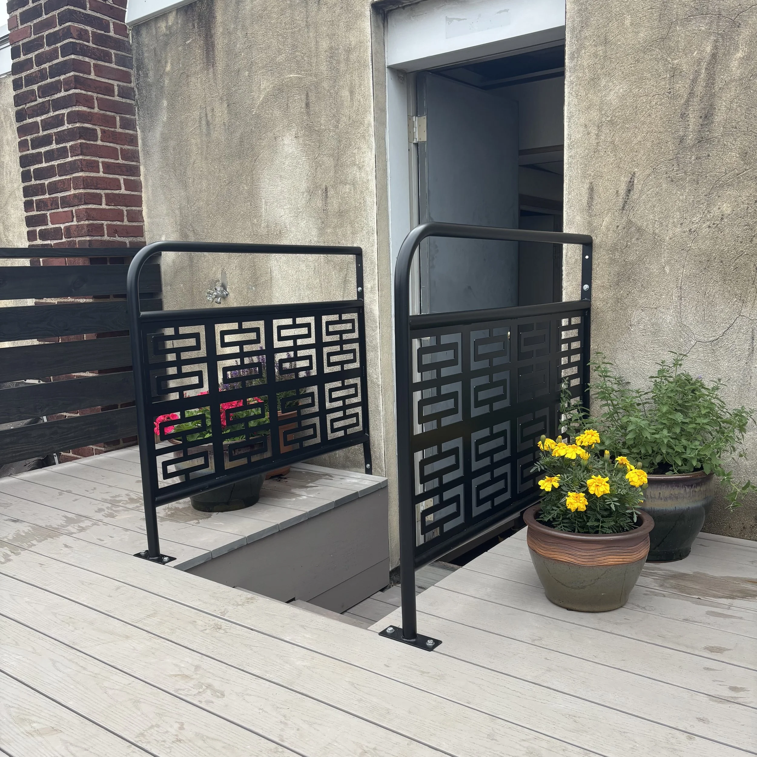 Breeze block & bent tube guard rails for back deck stairs.