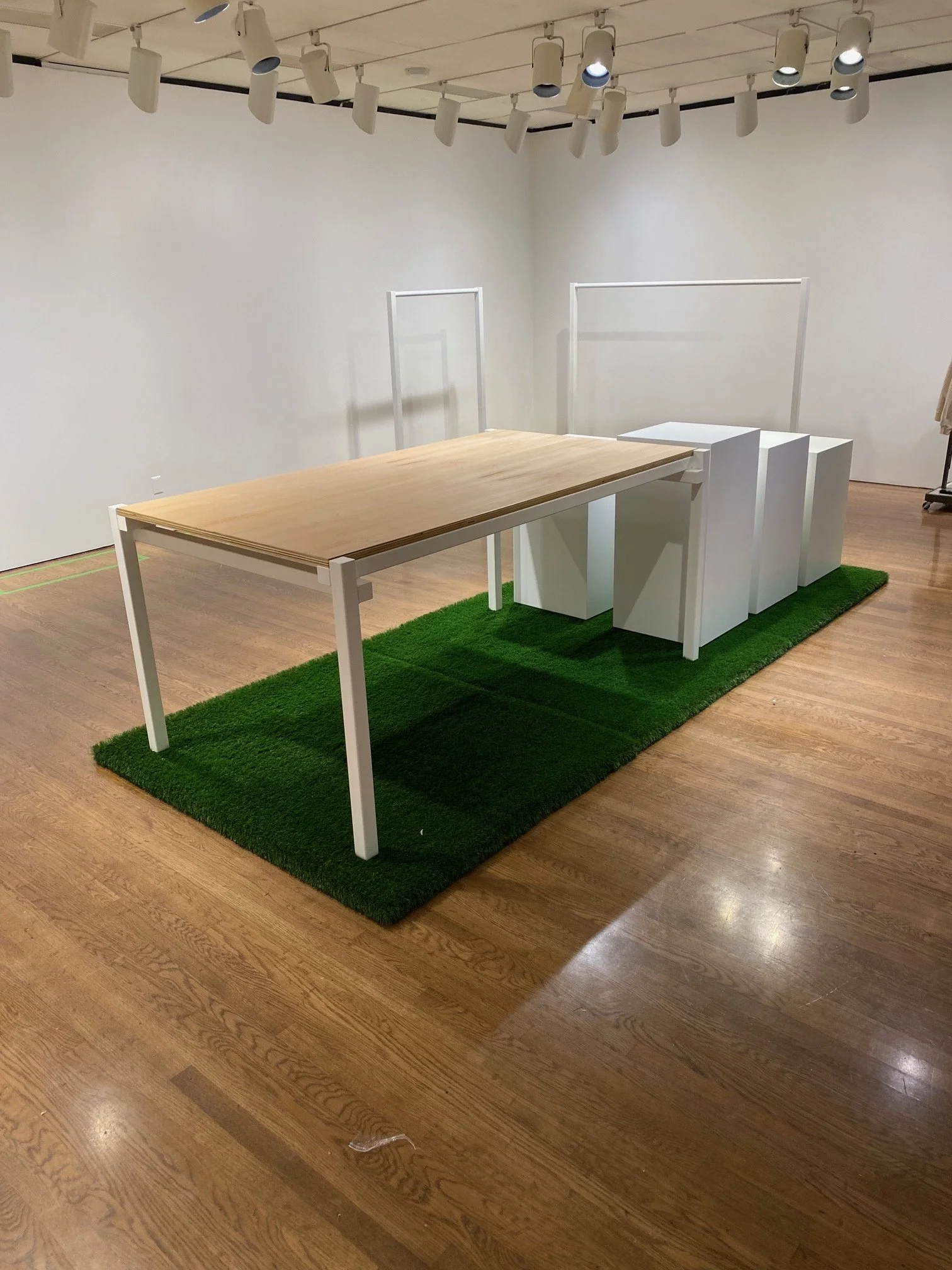 White Steel clothing racks & white steel plywood table on display at the Philadelphia Museum of Art Shop. 