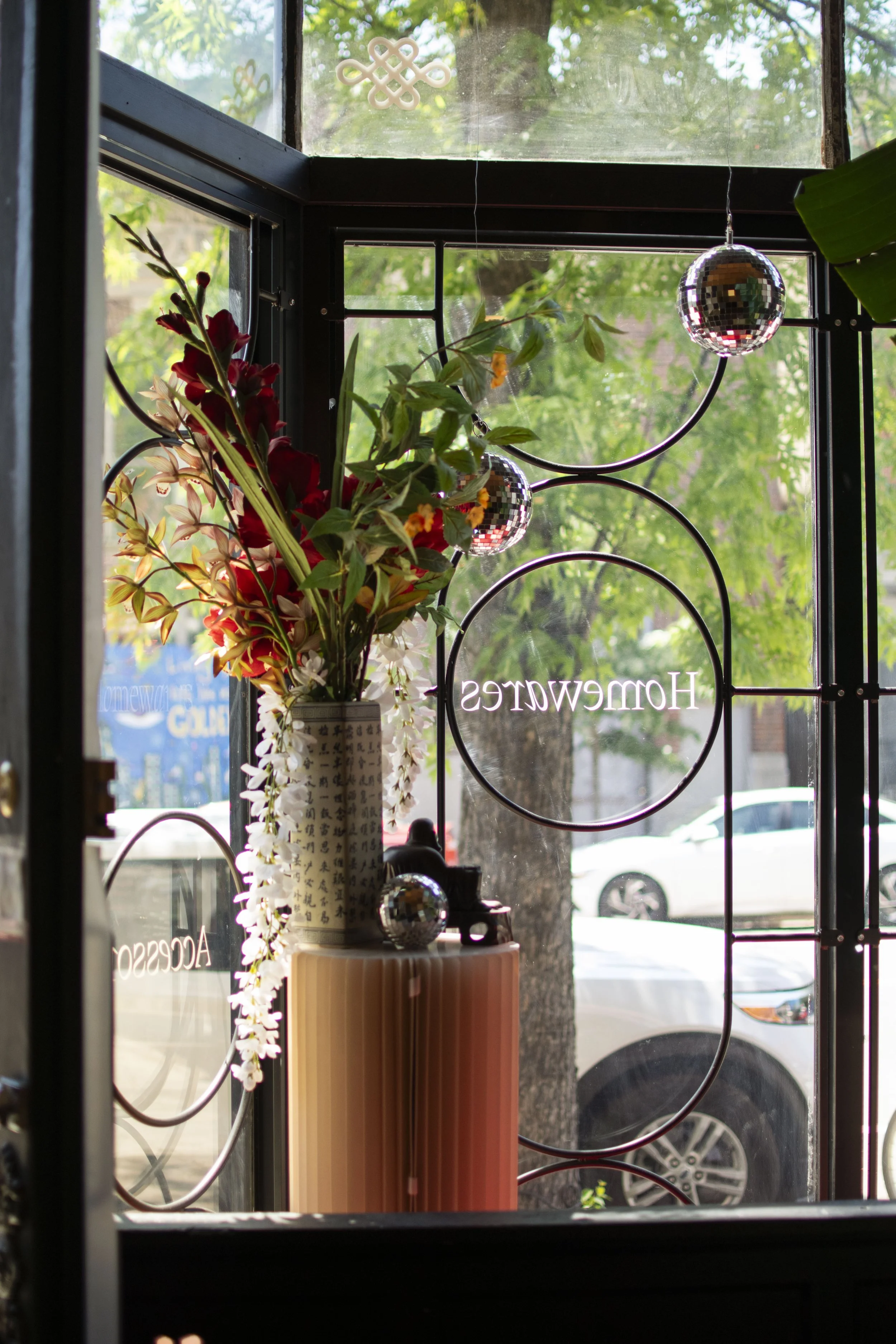 Decorative window bars shown from inside the shop. Round steel bars bent into a pill shape and circles. 