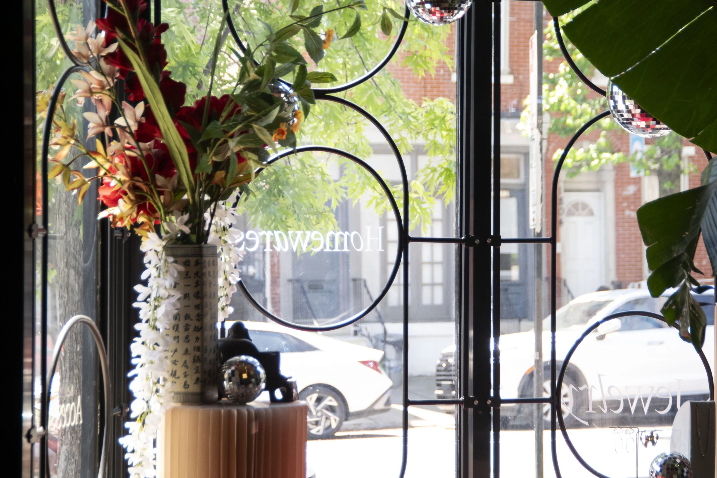 Decorative window bars shown from inside the shop. Round steel bars bent into a pill shape and circles. 