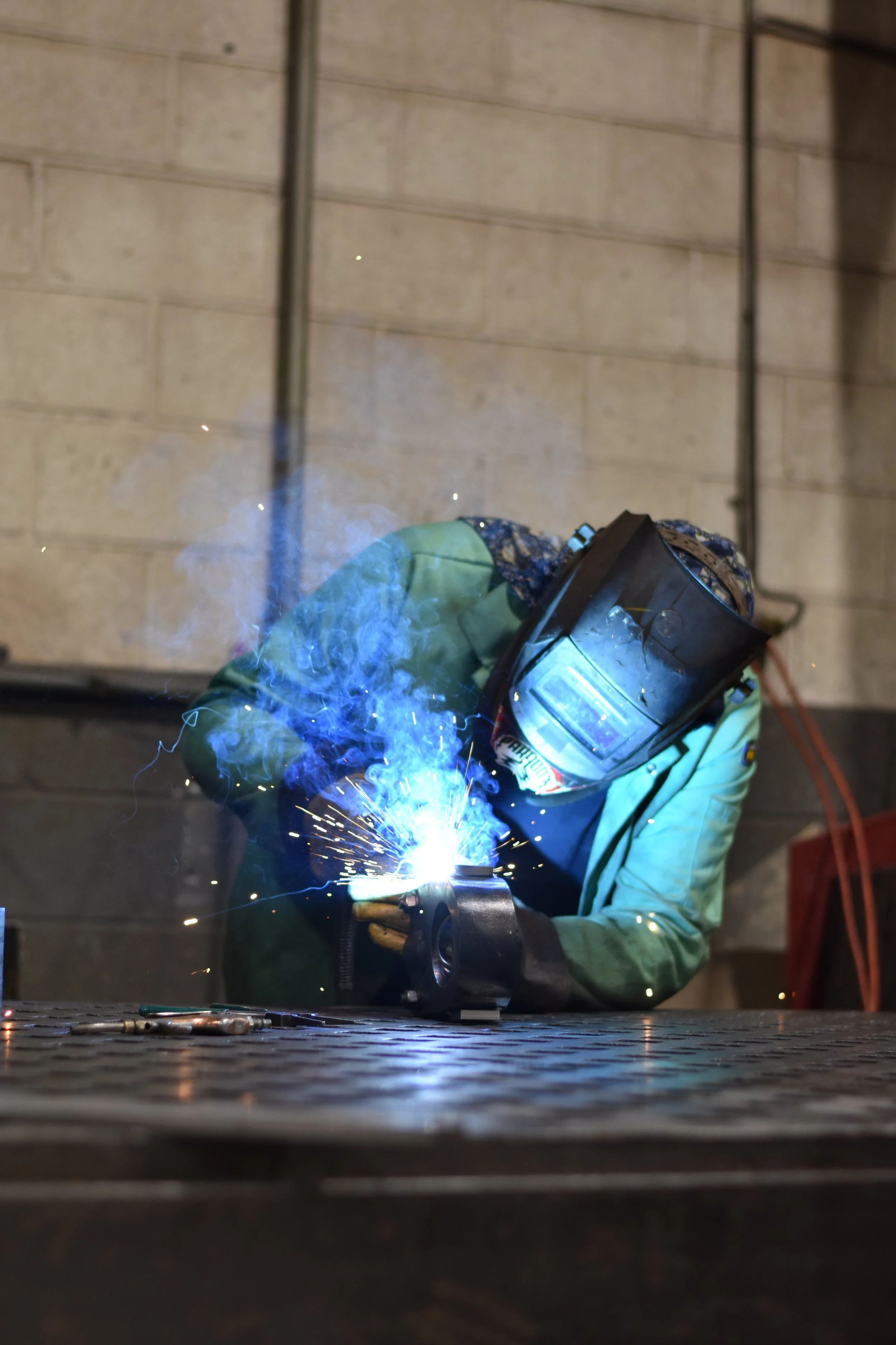 blue sparks from welder on steel