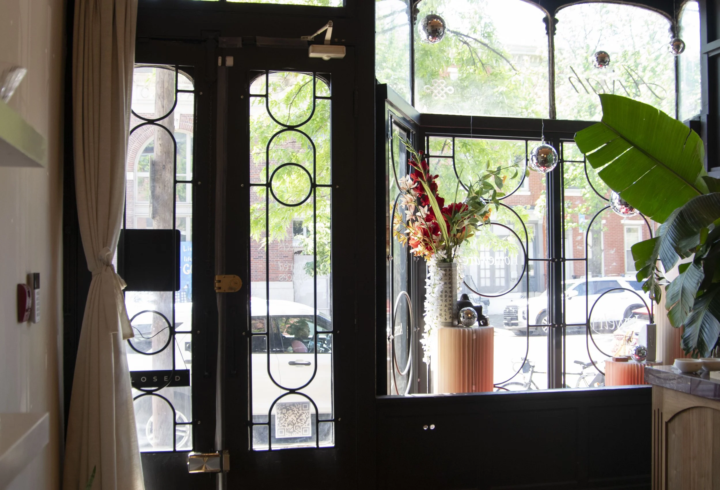 Decorative window bars shown from inside the shop. Round steel bars bent into a pill shape and circles. 
