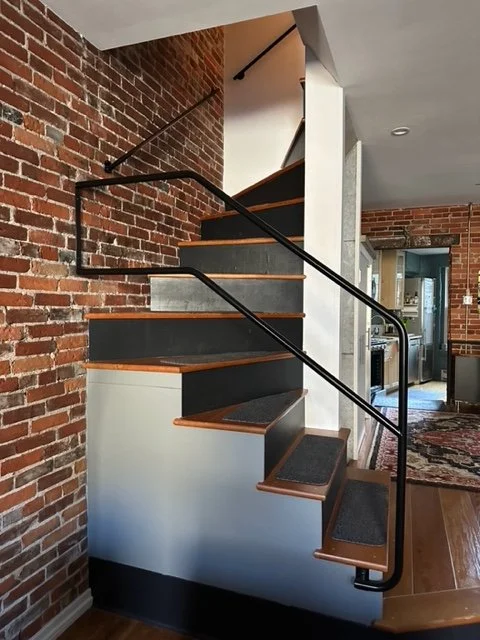 Black railings in old trinity style house. 