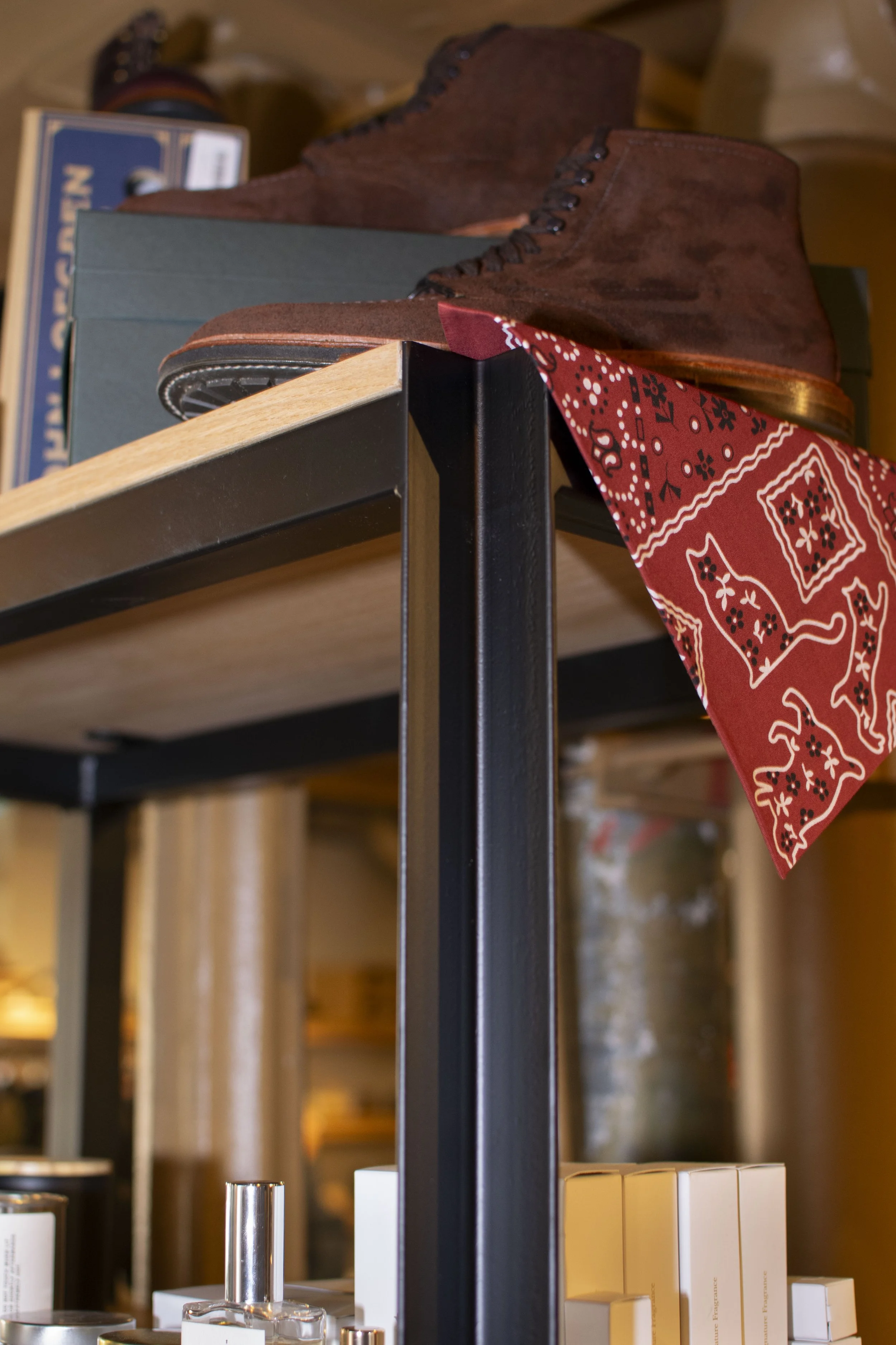 Detail of Steel and wood shelf holding various Men's grooming products