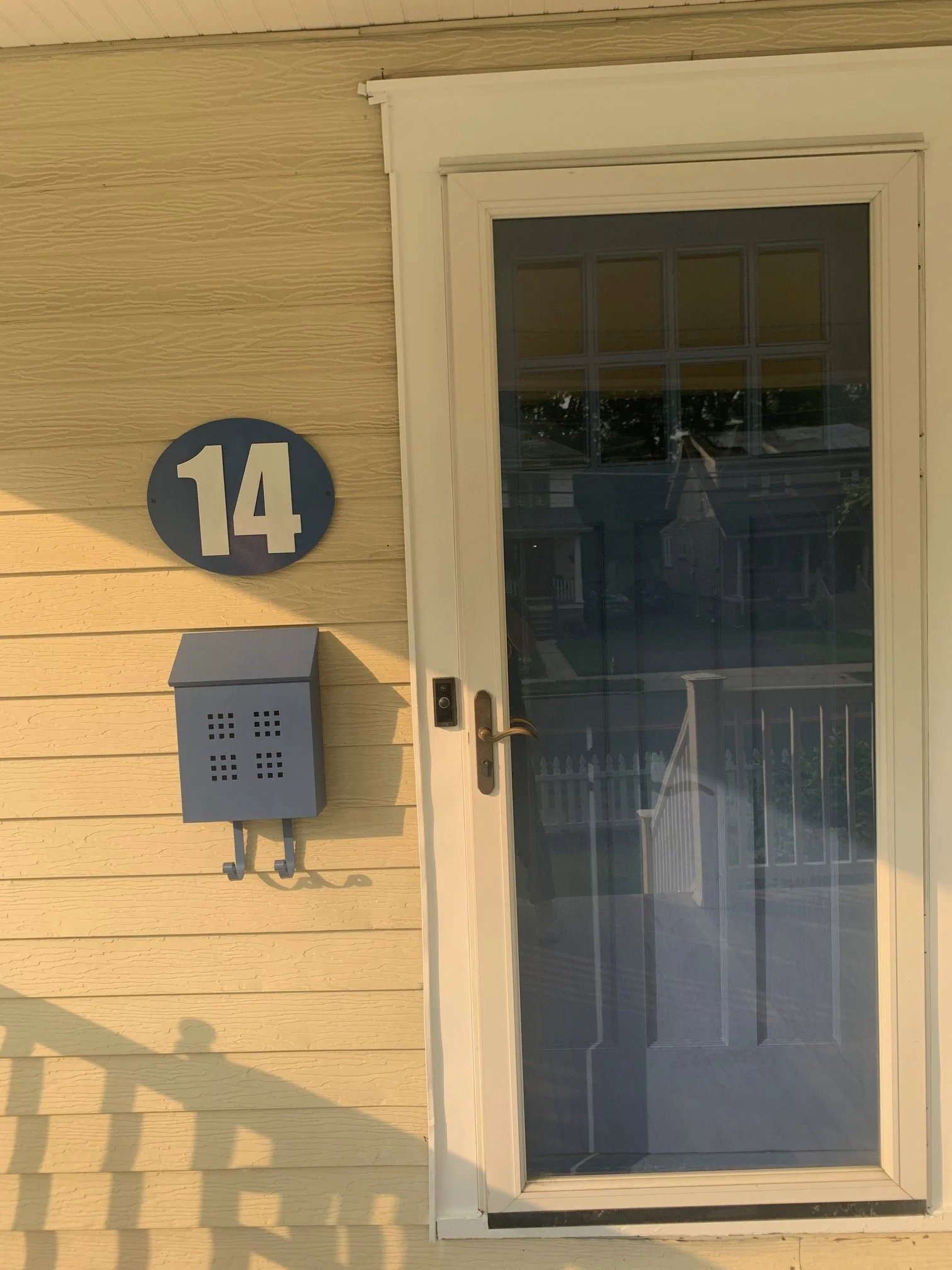Blue and white house number sign