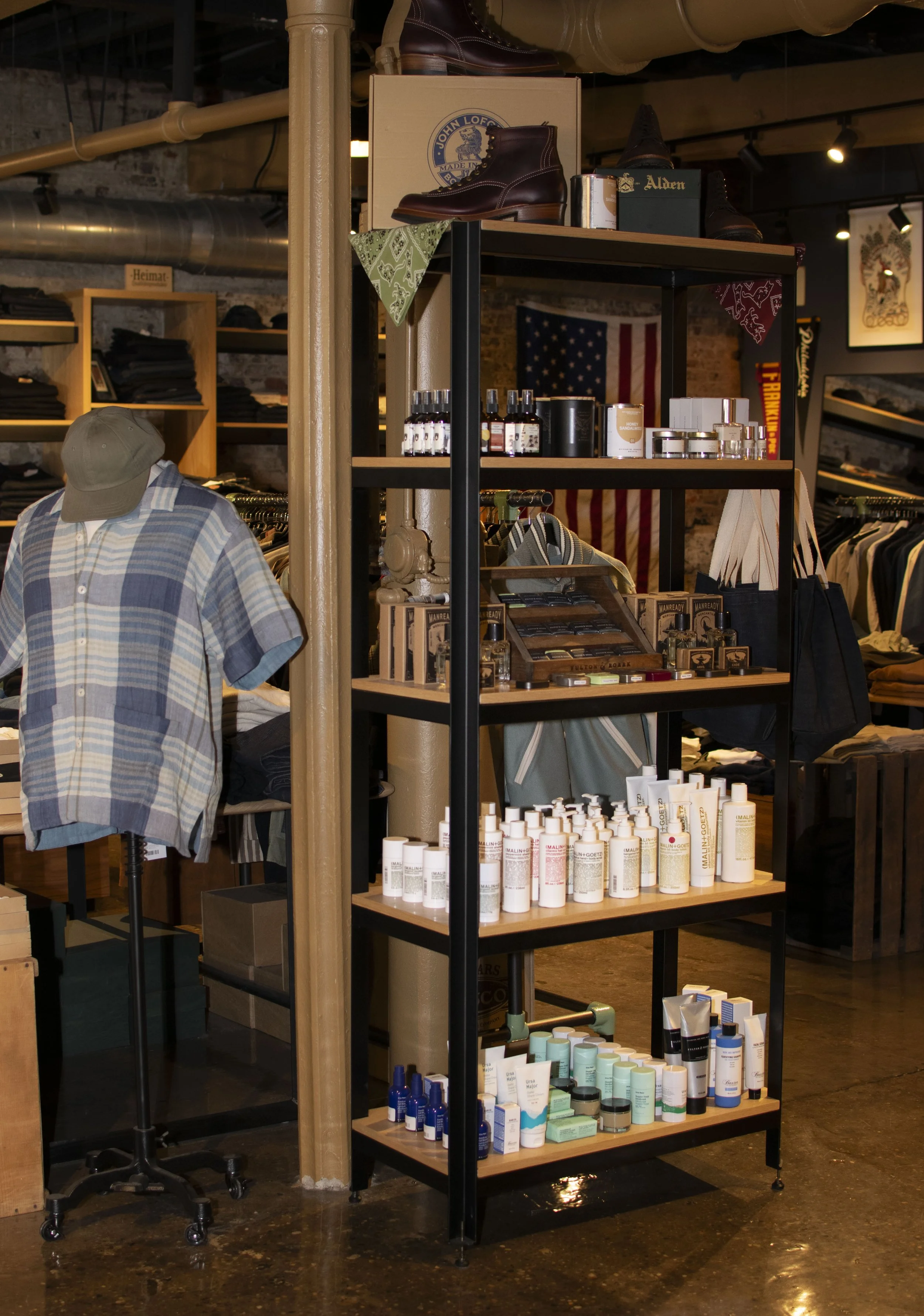 Steel and wood shelf holding various Men's grooming products