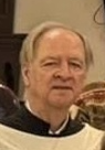 Close-up of  man with light hair and a solemn expression.