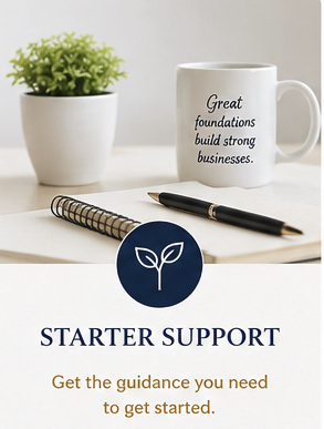 A white notebook, a ballpoint pen, a white mug with a quote about building strong businesses, a small potted green plant, and a starter support guide with a leaf logo and motivational text on a white surface.