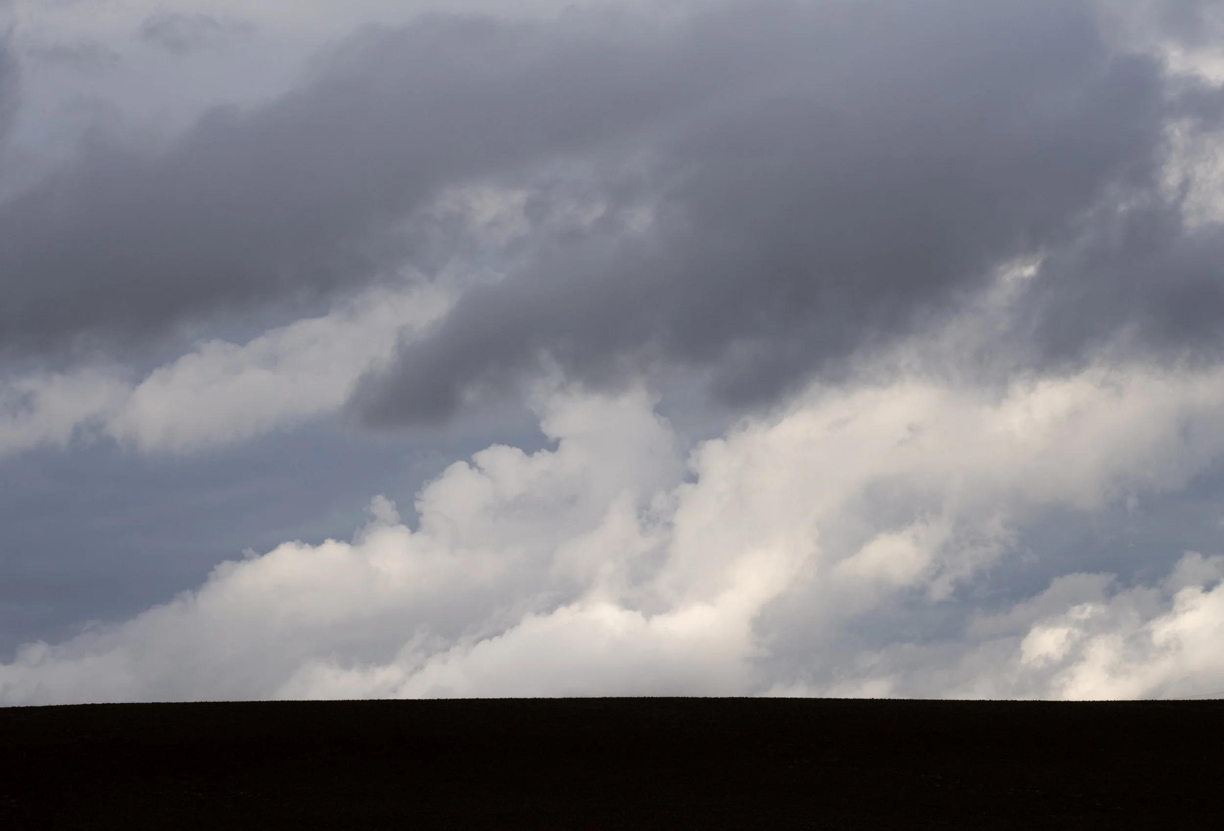 Storm clouds dominate the ridgeline