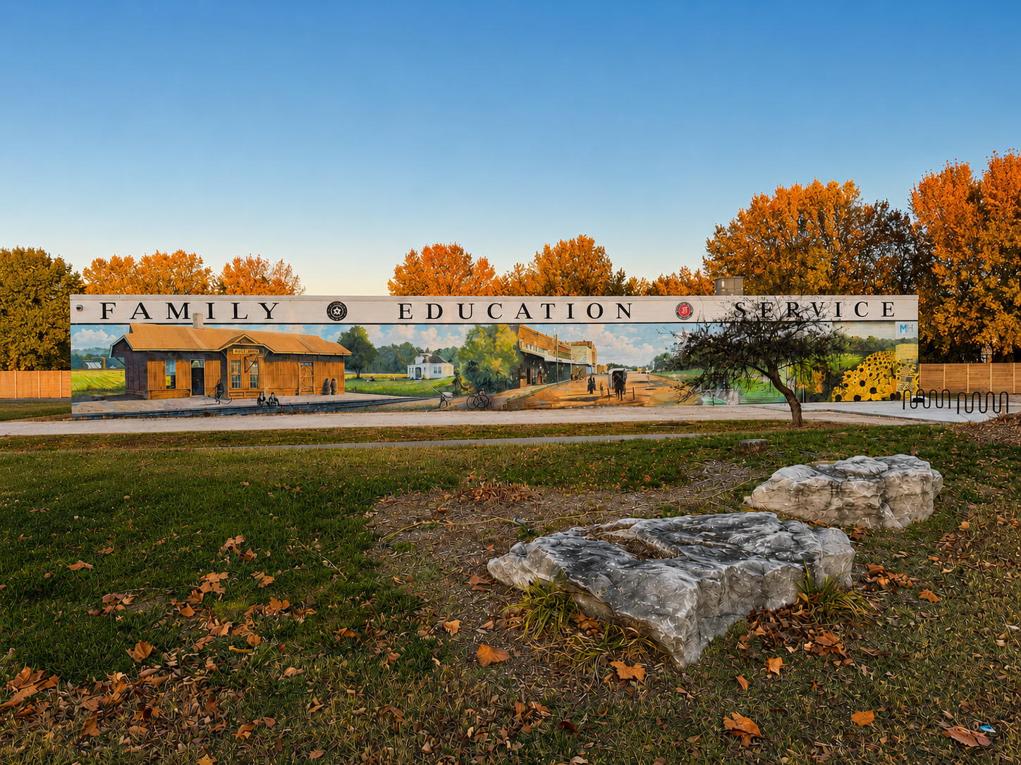 Exterior mural on Mile 6 Taproom showing rural community scenes and the words Family, Education, Service in a fall setting.