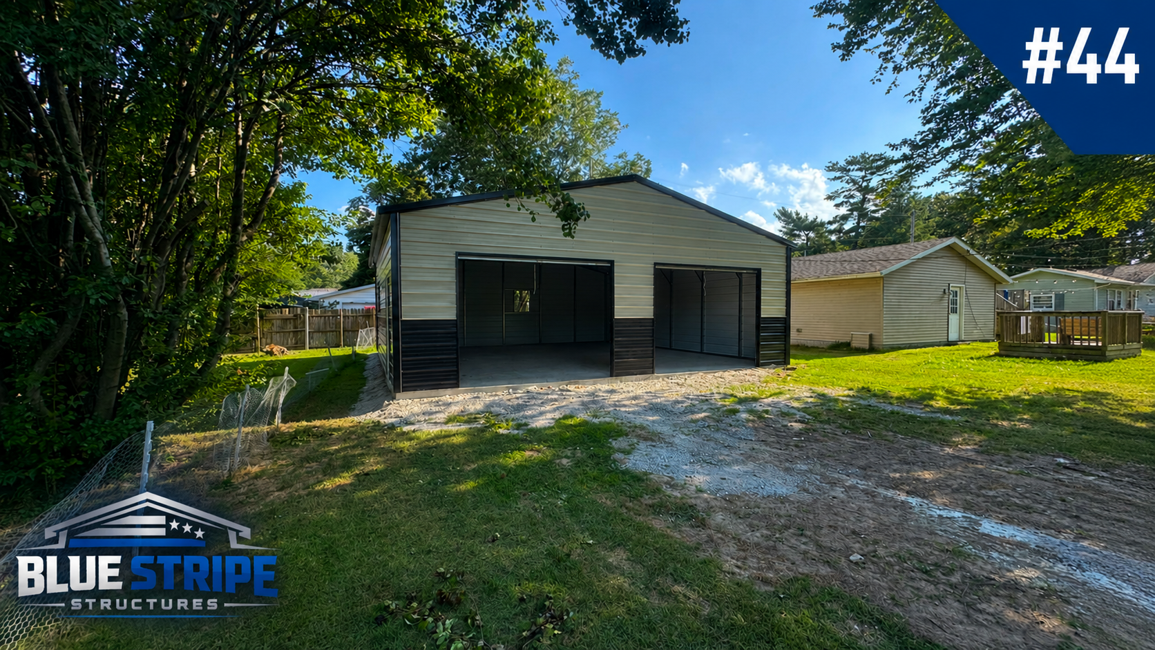 Residential dual-bay metal garage with black garage doors