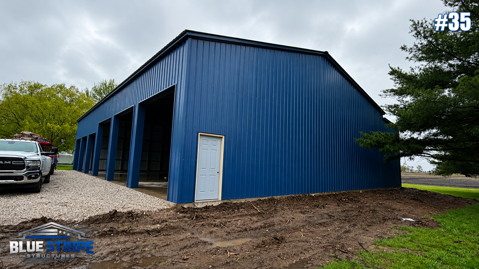 Oversized blue steel commercial garage building with tall openings