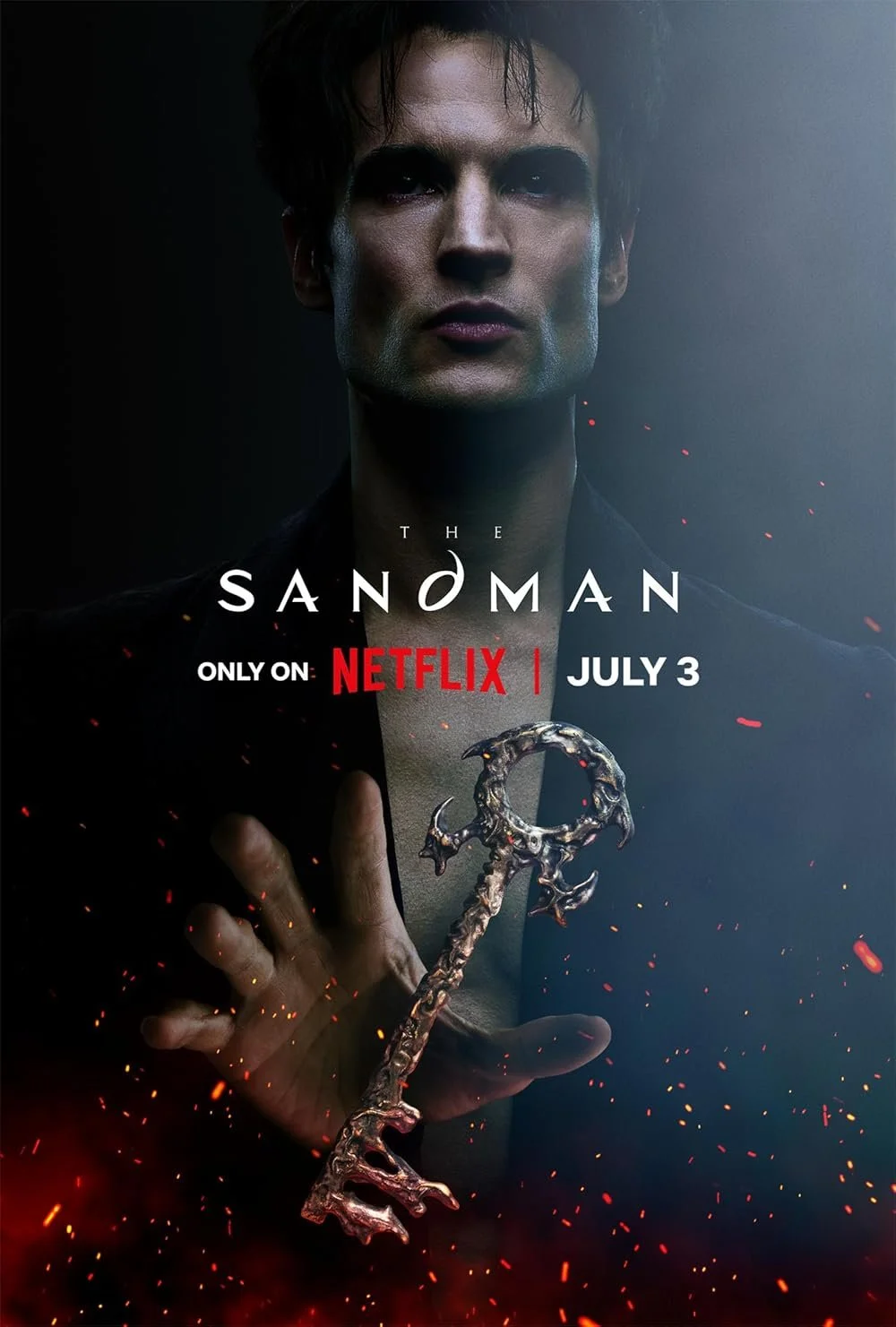 Promotional poster for the series "The Sandman" featuring a person with dark hair holding a mystical, metallic object, with fiery embers around, on a dark background, indicating it is available on Netflix starting July 3.