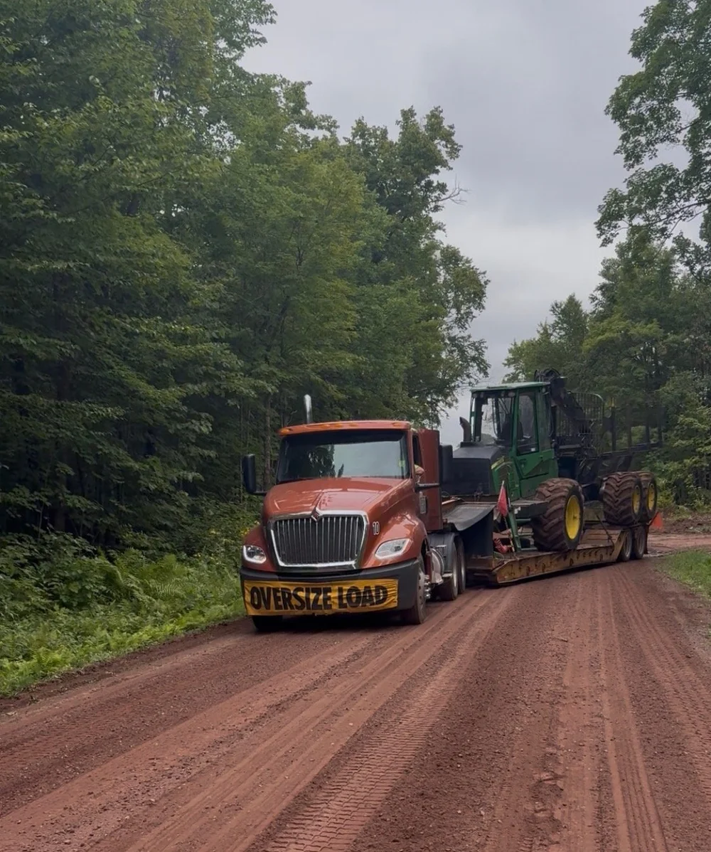Foster Land and Timber lowboy transporting equipment