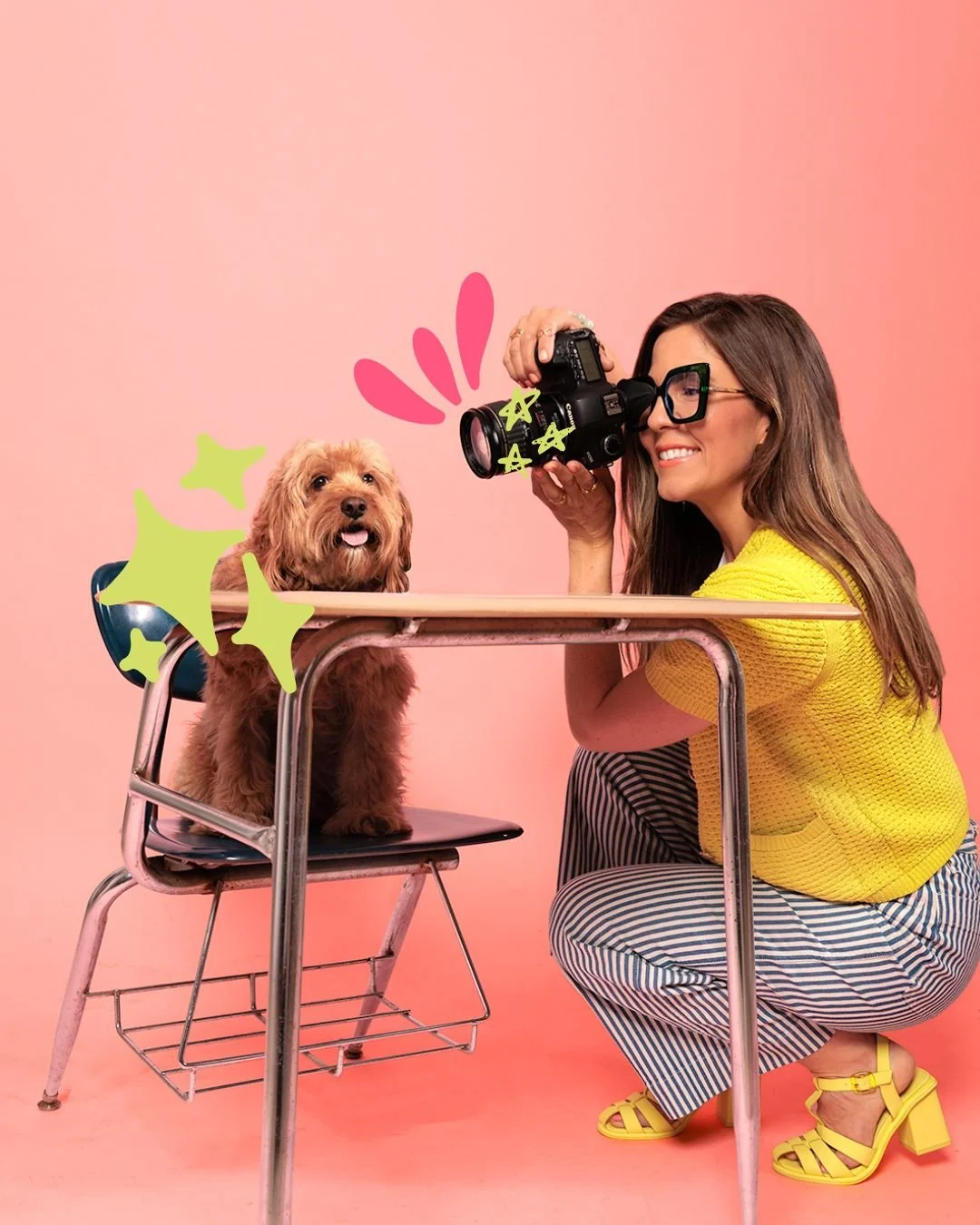 A woman with long brown hair, glasses, and a bright yellow top is taking a photo of a small, fluffy, brown dog sitting on a desk. The background is pink, and there are colorful digital decorations added around the dog and woman.