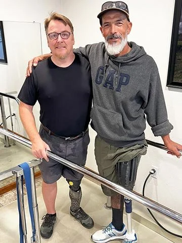 One Leg At A Time recipient wearing a Quatro Adjustable Socket pictured next to Quorum Prosthetics CEO and founder Joe Johnson.