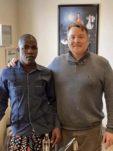 Gilbert, a One Leg At A Time recipient, standing beside prosthetist Joe Johnson. Learn more about Gilbert’s story and the prosthetic care he received.