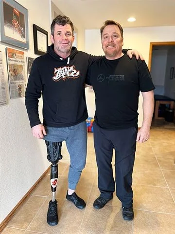 Quorum Prosthetics CEO and founder Joe Johnson pictured with a happy patient showing their Quatro Adjustable Socket.