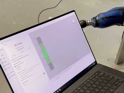 Animated gif showing a prosthetic leg being 3D scanned to collect digital measurements for custom prosthetic fabrication, while a computer screen displays the scan in real time.