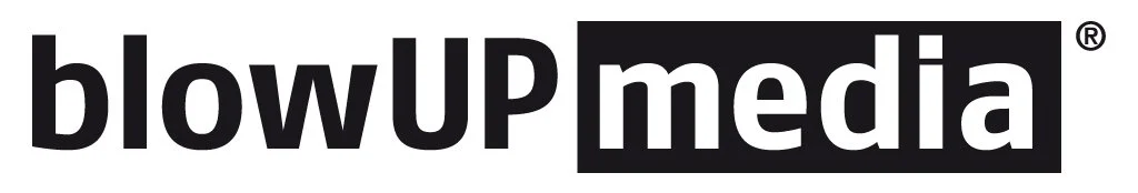Logo with bold black text saying "blowUP media" on a white background.