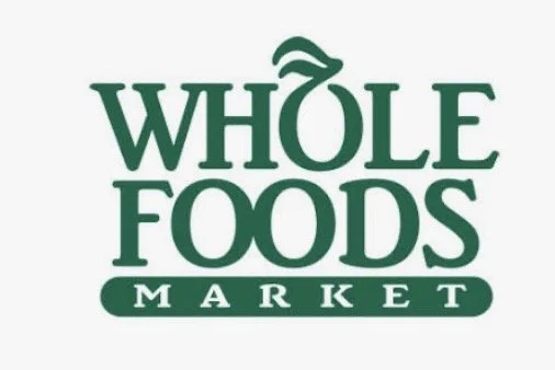 Whole Foods Market logo in green text with a stylized leaf above the 'O' in Whole.