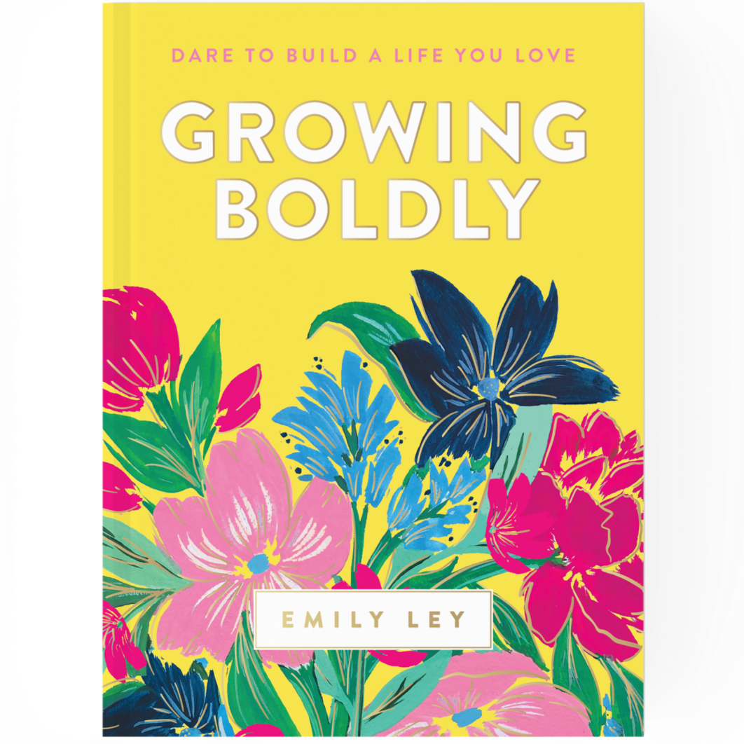 Book cover titled 'Growing Boldly' by Emily Ley, with a yellow background and colorful illustrated flowers.