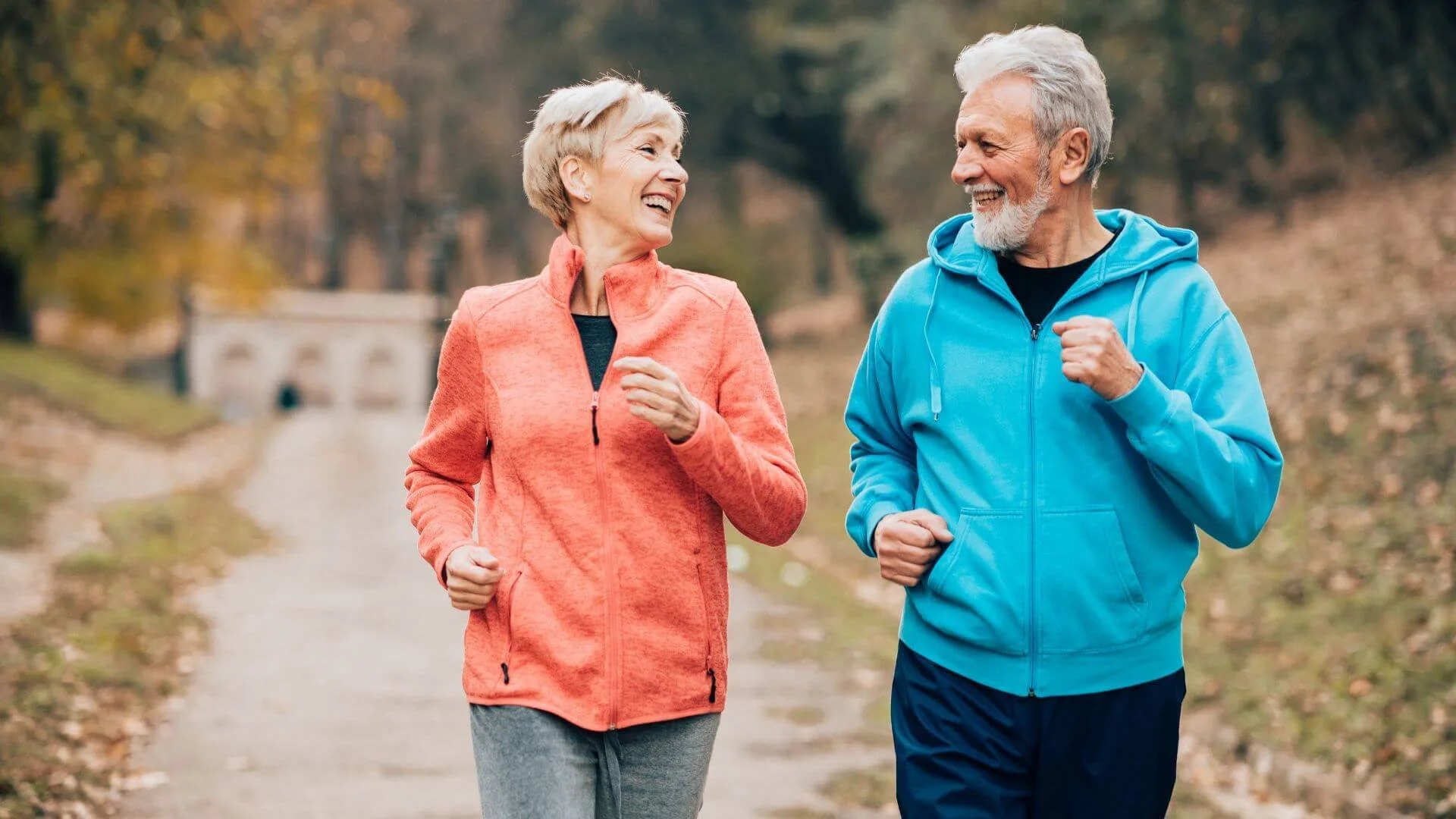 two people happily walking outside to get exercise
