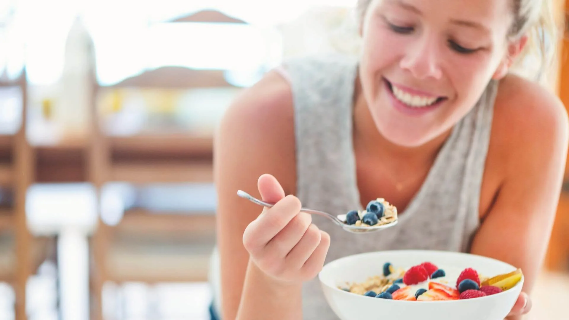 woman happily eating her healthy snack