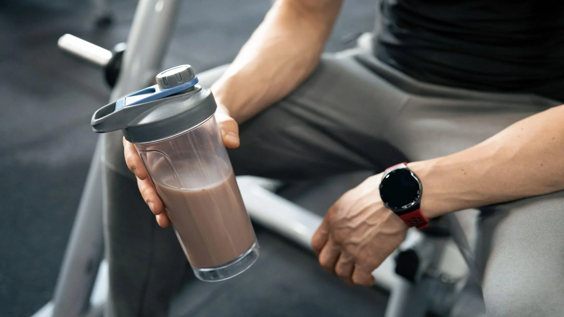 man holding a protein shake