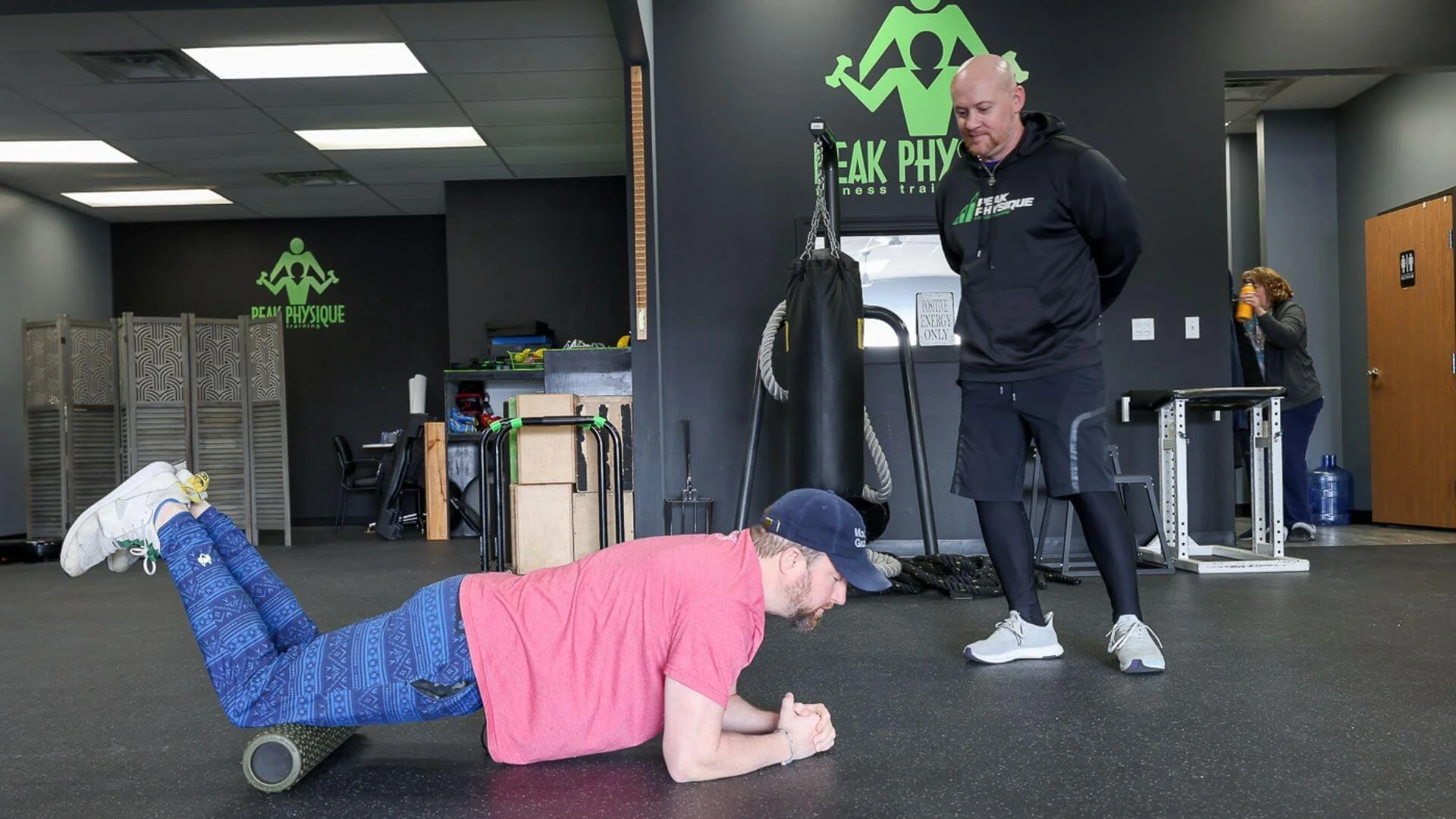 Nick, personal trainer in troy, helping a client with an exercise