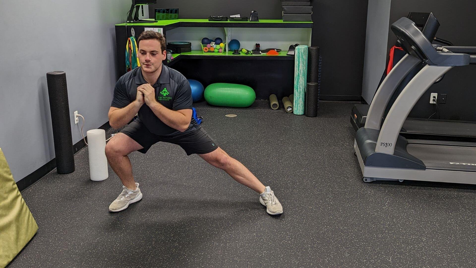 personal trainer showing how to do a strength building exercise