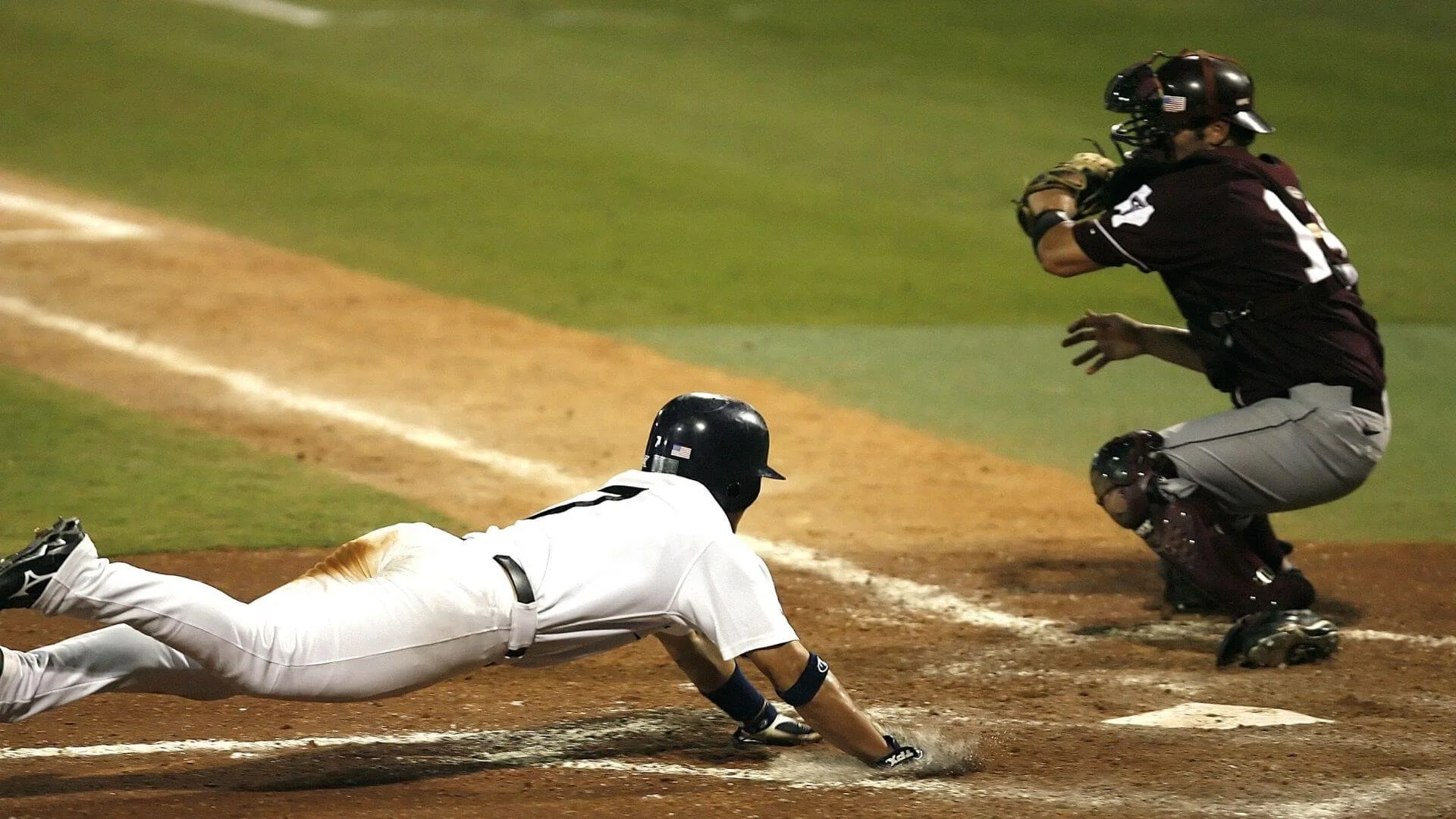 baseball player sliding into homebase
