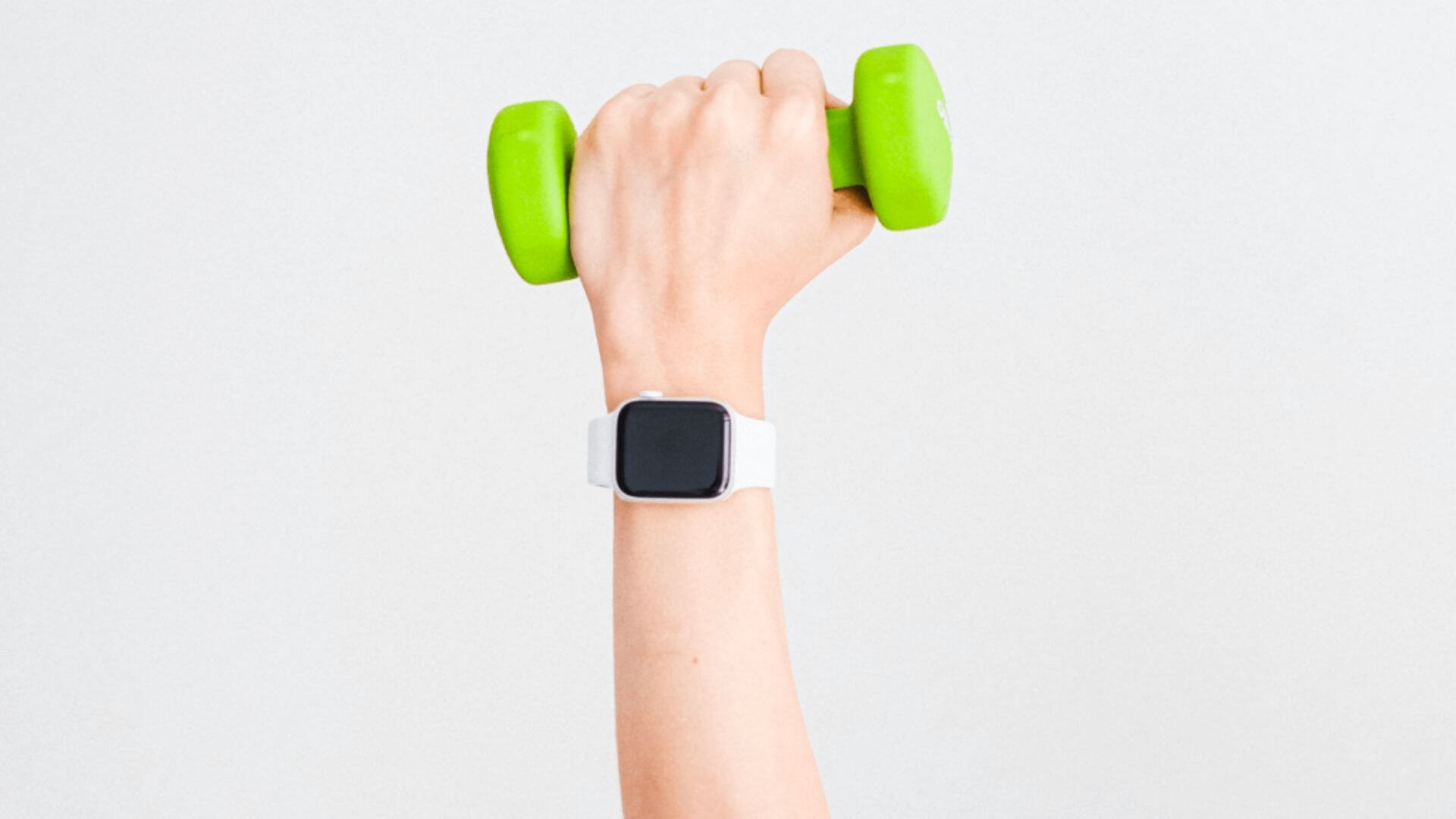 hand holding a bright green dumbbell