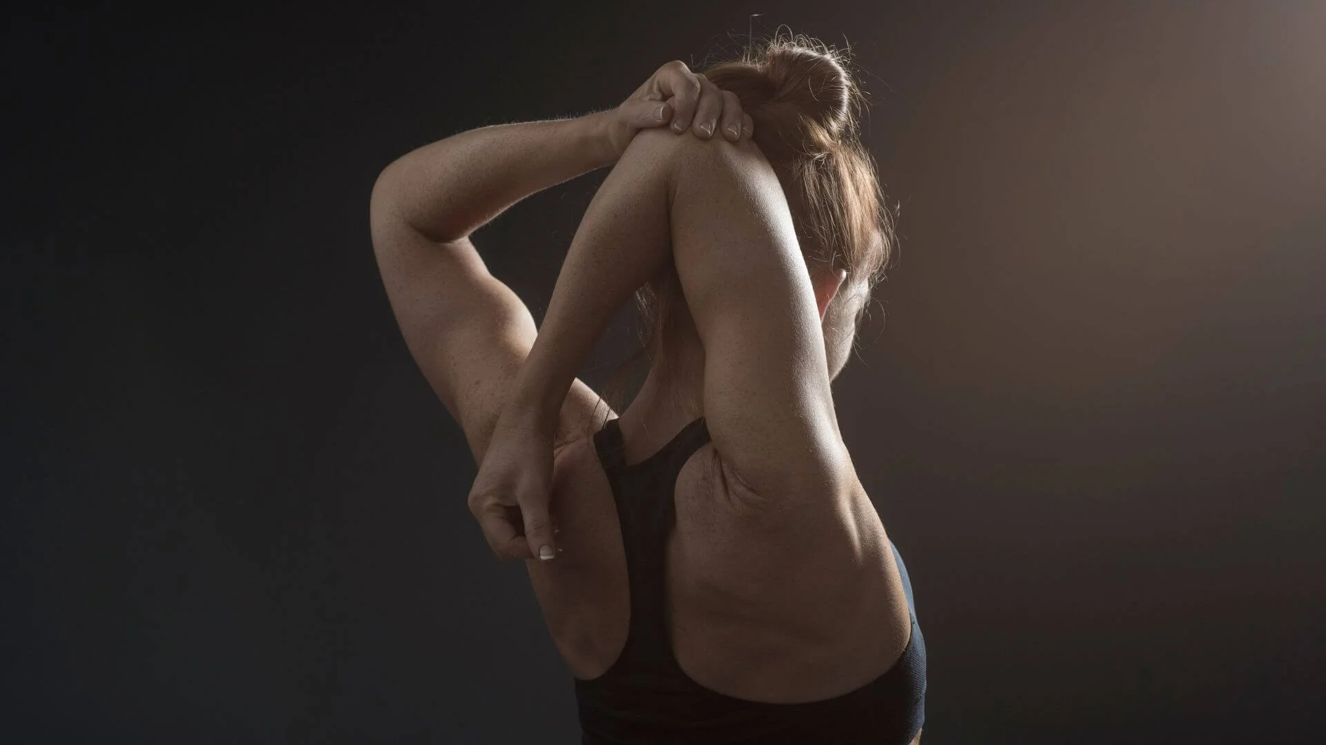 woman doing a back stretch to help with pain