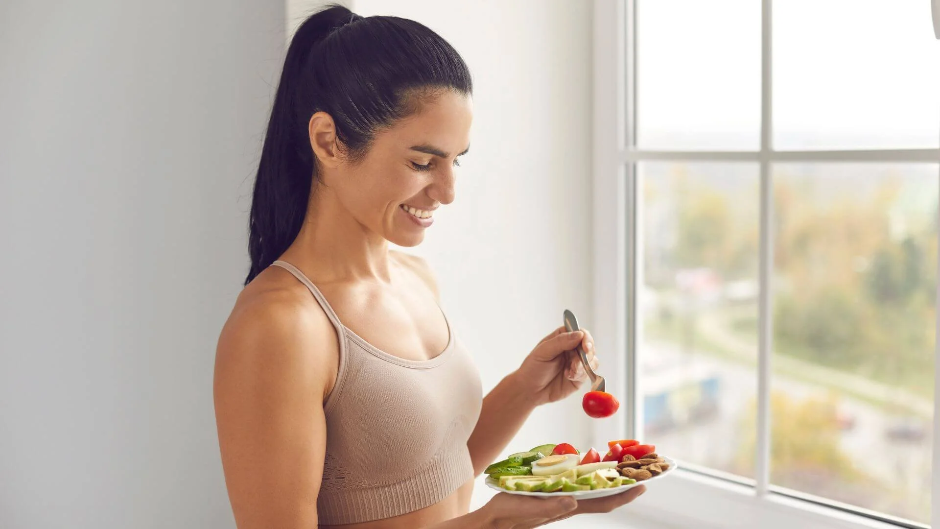 woman happily eating her healthy food