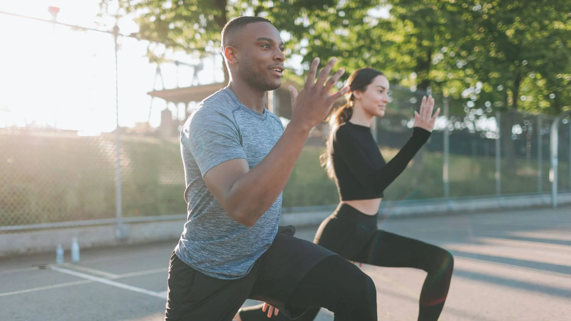 two people outside exercising