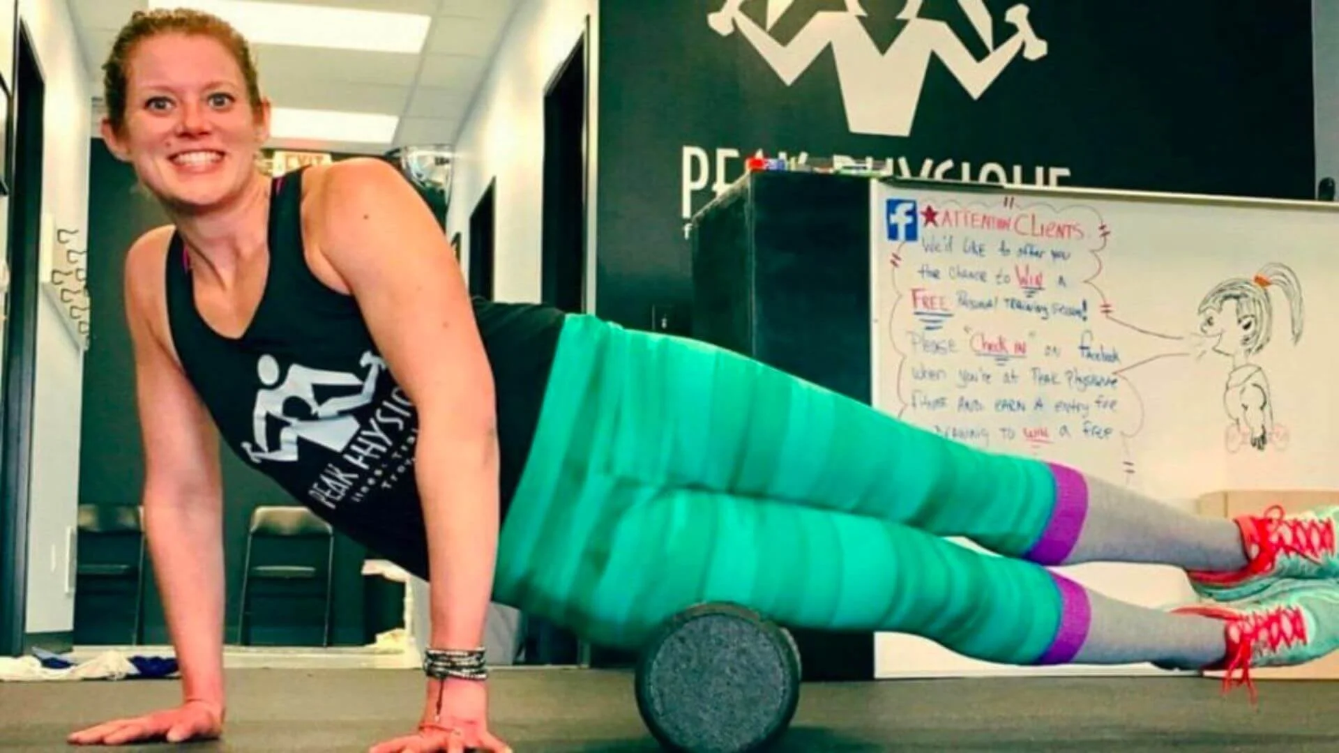 lissa, personal trainer, foam rolling her hip and leg