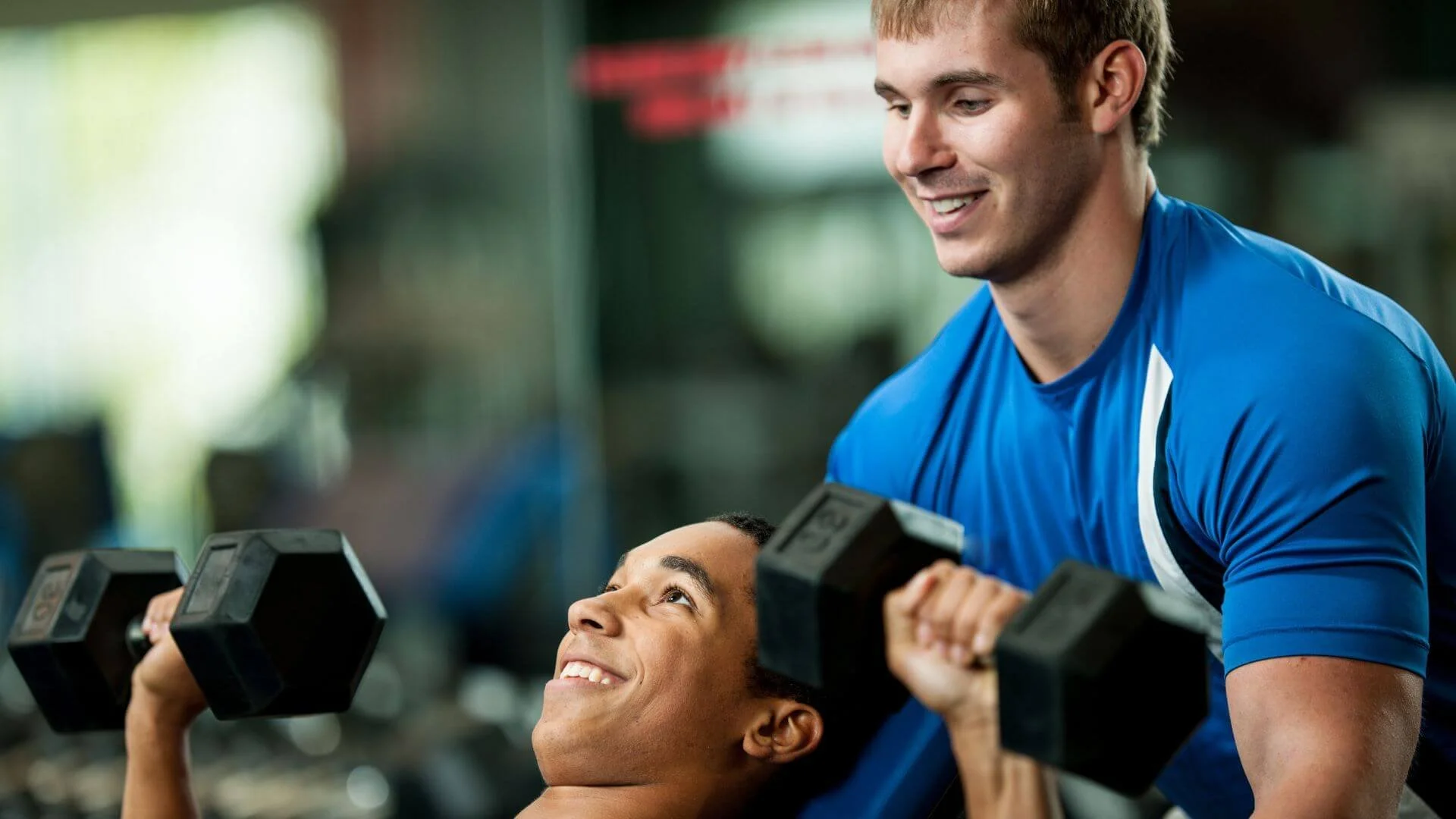 personal trainer helping a client strength train