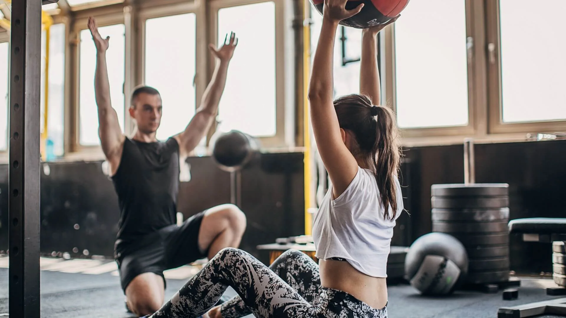 personal trainer showing a client how to do an exercise