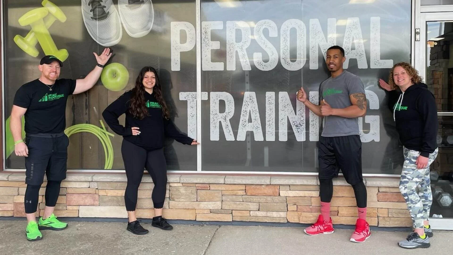 personal trainers standing in front of peak physique, a gym in troy michigan