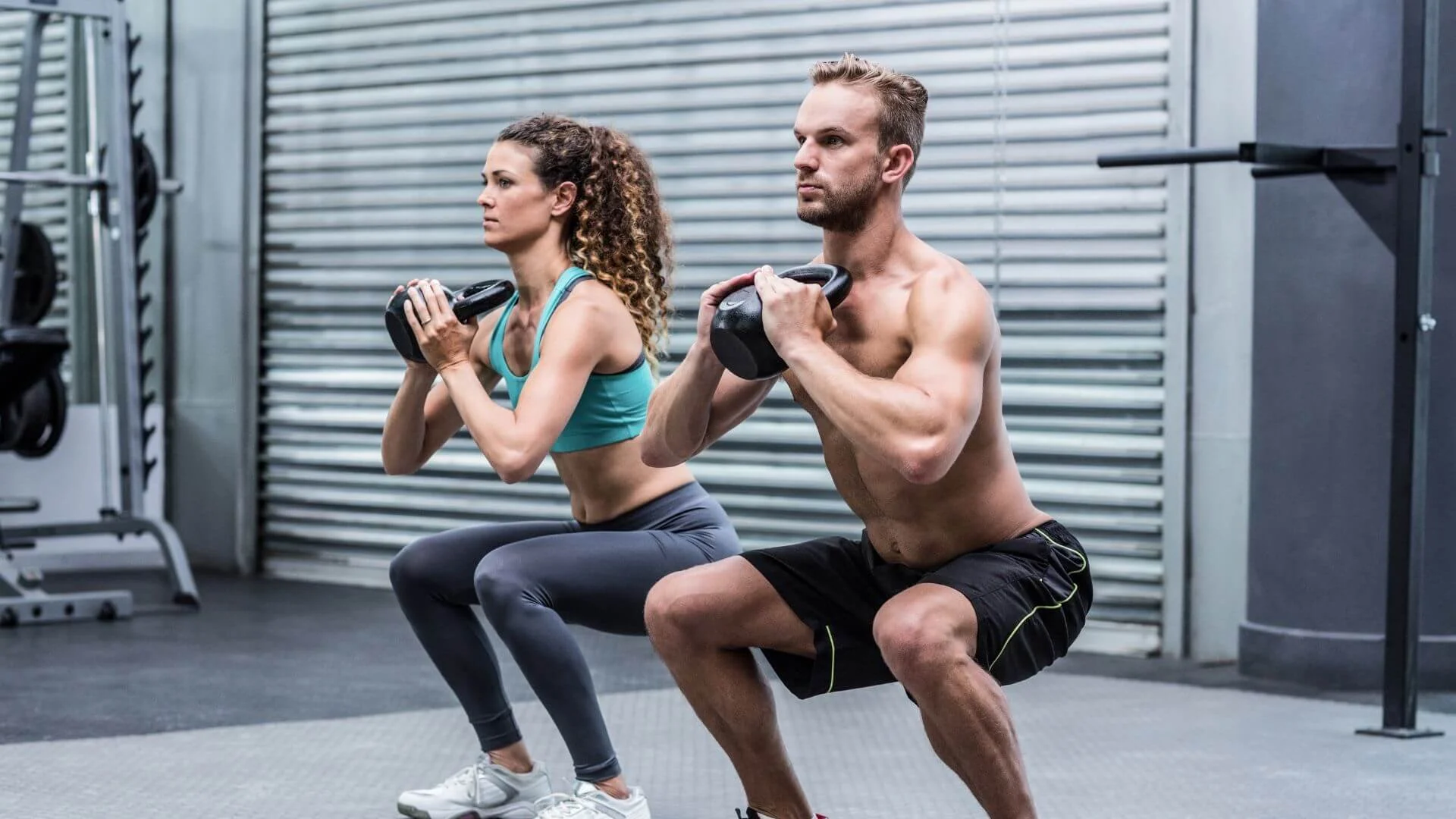 two people doing squats together to exercise