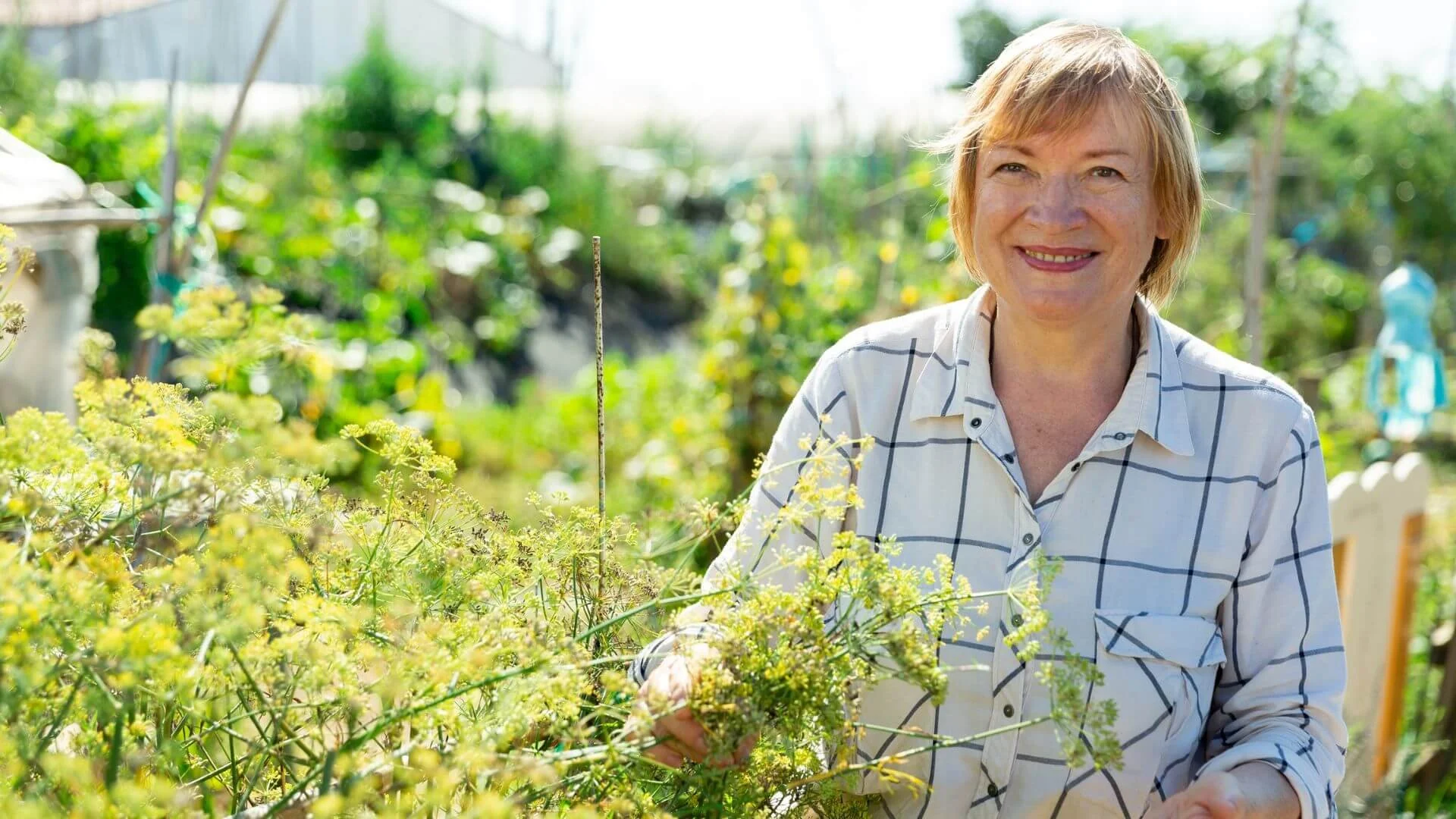woman smiling happily while gardening