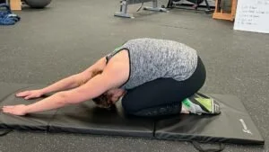 personal trainer showing how to do a Child’s Pose