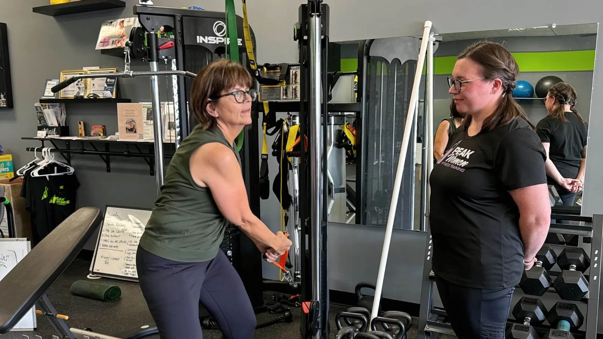 personal trainer watching a client exercise