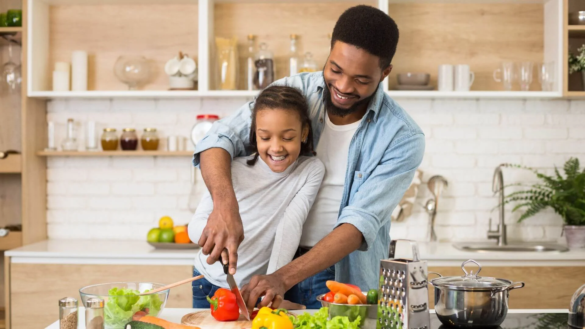 man in the kitchen cooking high protein meals with his daughter