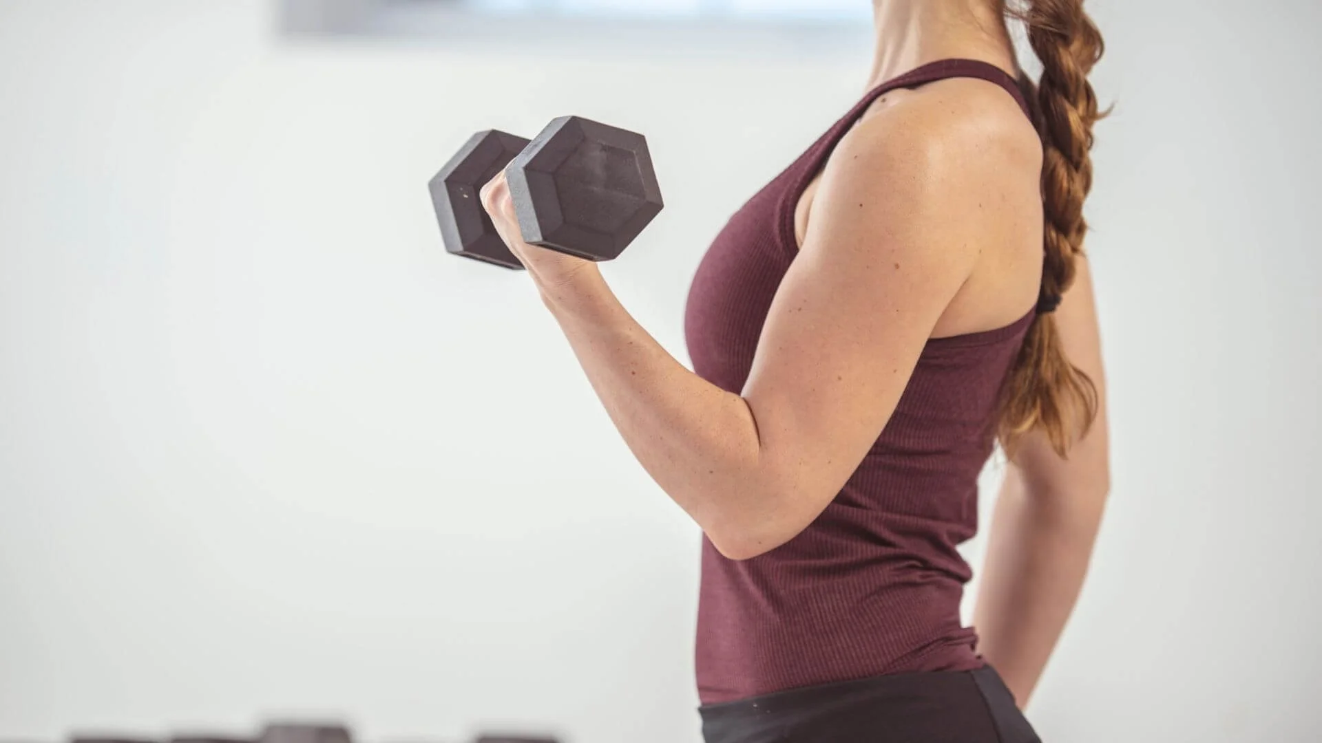 woman holding a weight while exercising