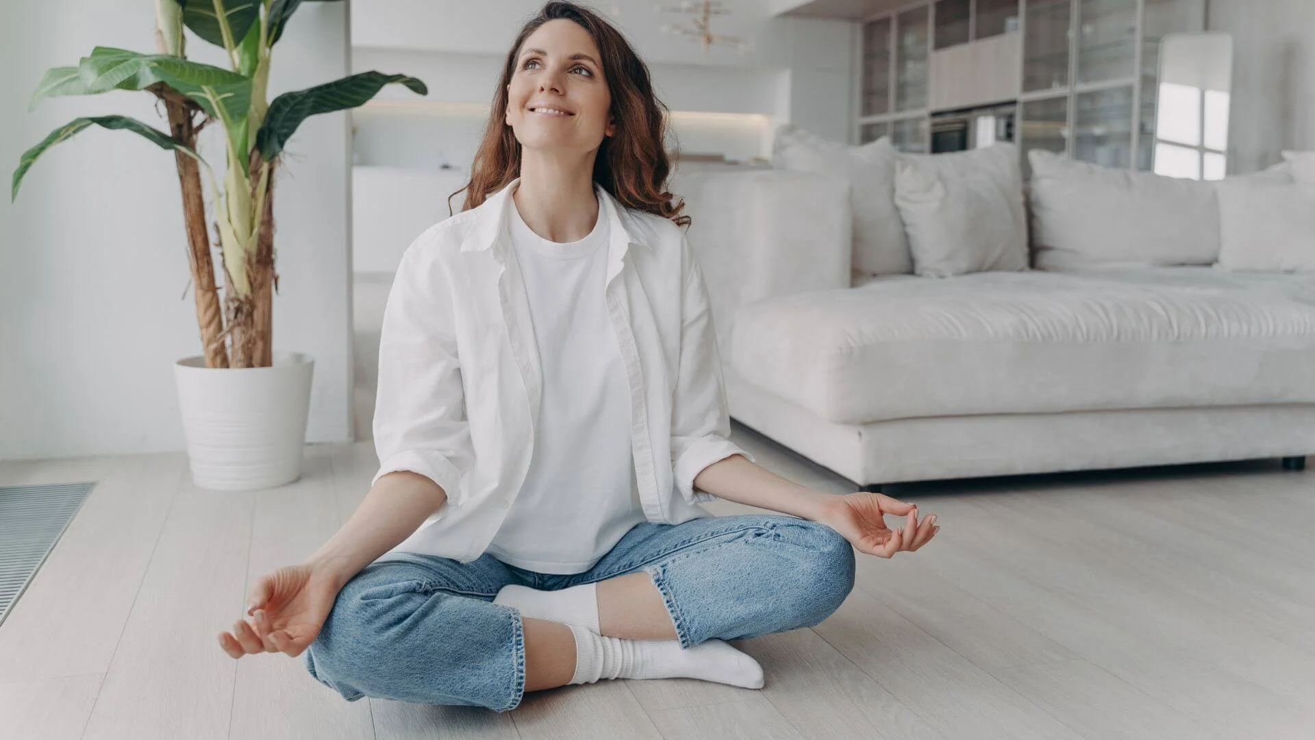 woman happily and comfortably on the floor doing yoga