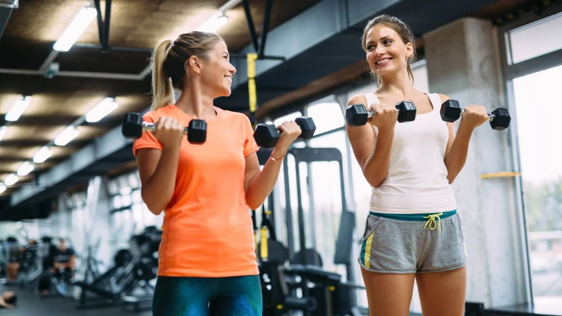 two women happily exercising togther