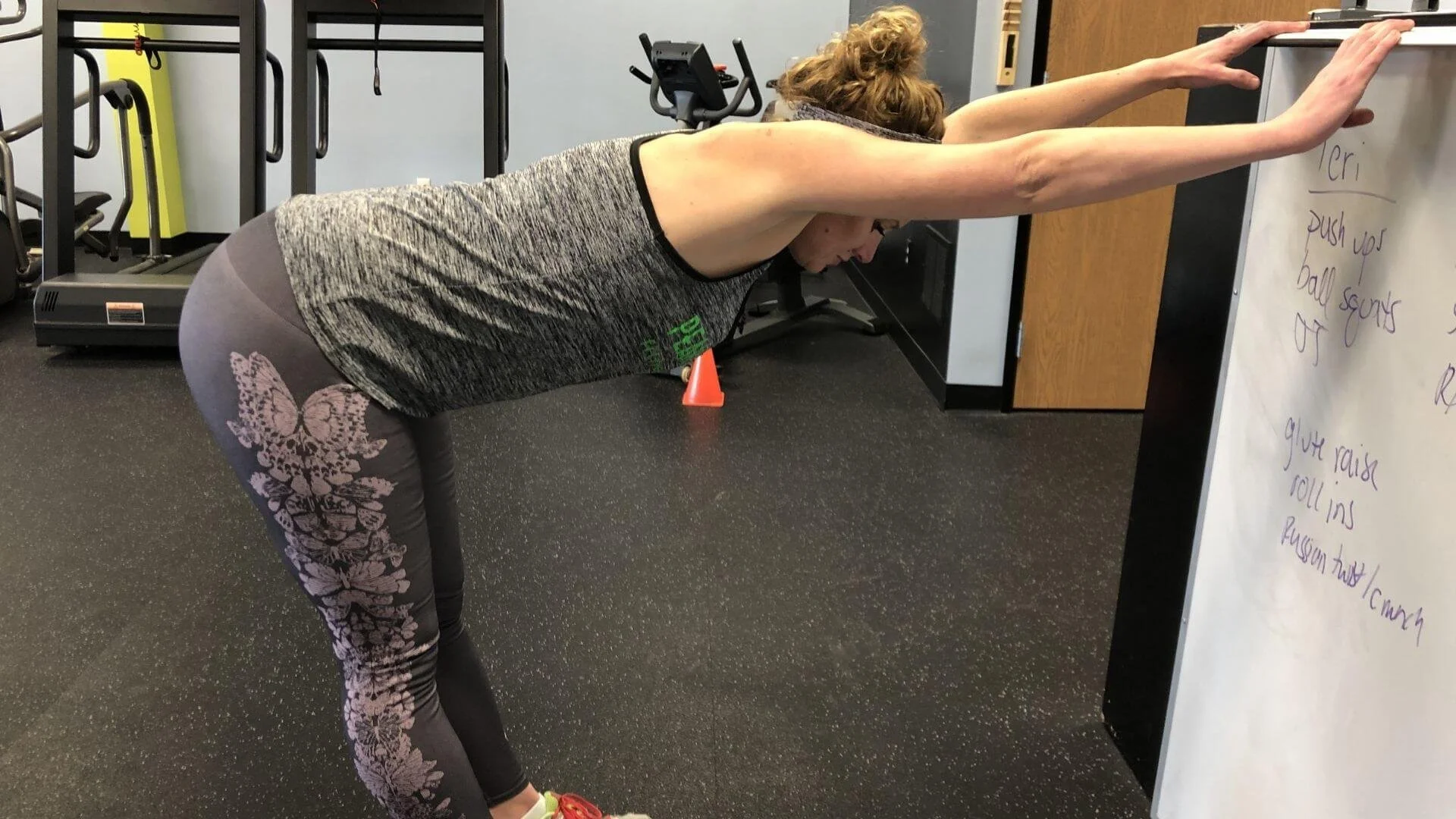 lissa, personal trainer in troy, michigan doing a Standing Kitchen Sink Decompression