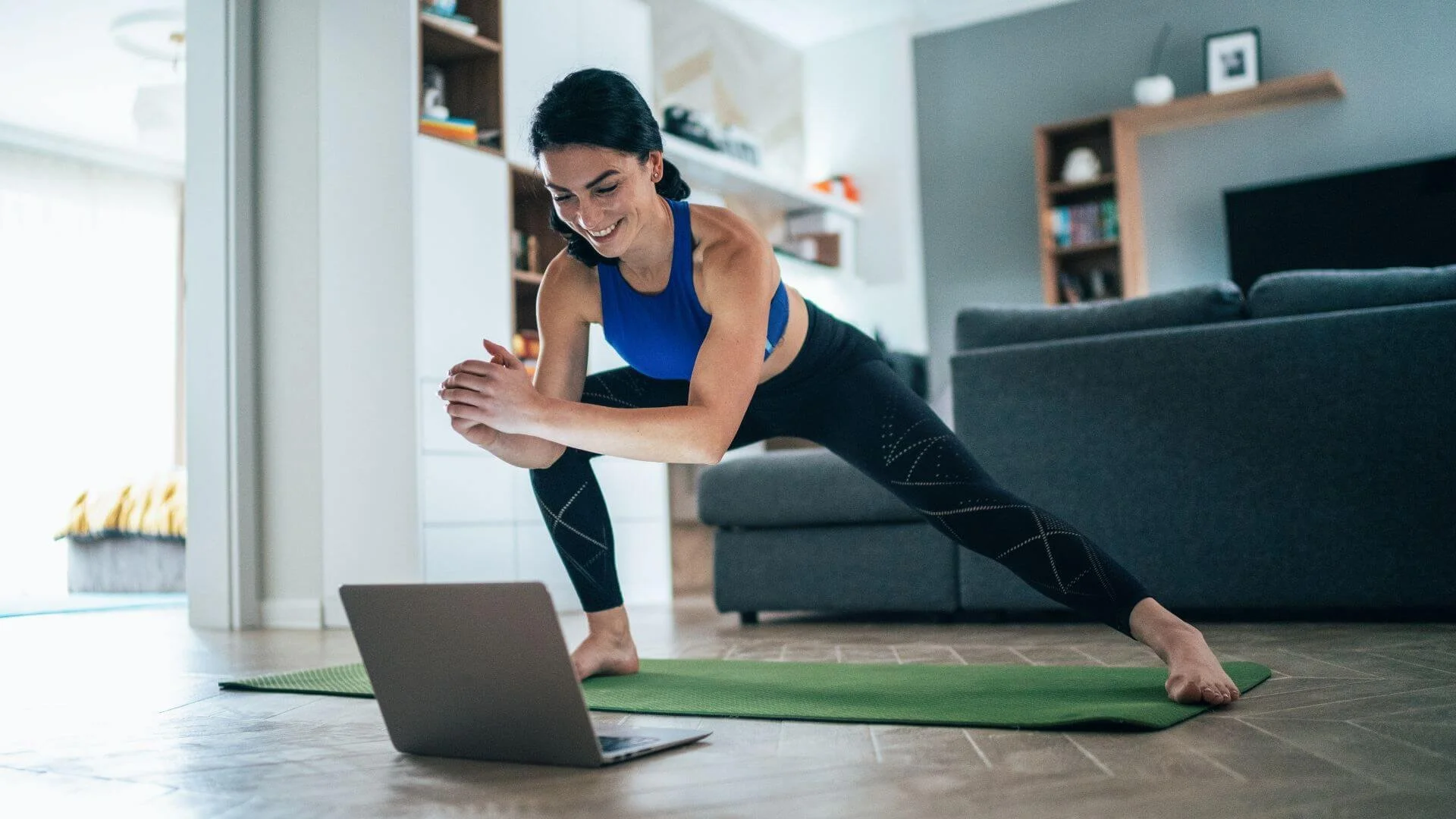 woman smiling and exercising online